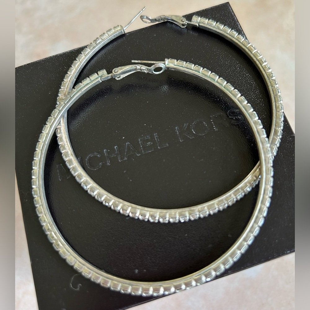 Large silver hoop earrings with crystal design